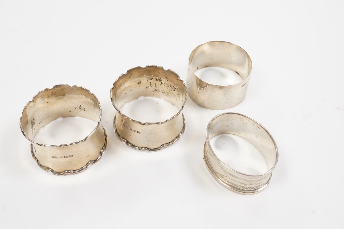 A collection of assorted silver to include five napkin rings including two pairs, a cased pair of glass butter dishes with silver butter knives, five golf related teaspoons, a cased set of six sterling cocktail sticks wi